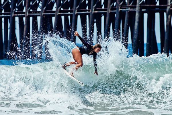 surfer surfing near Oceanside Pier